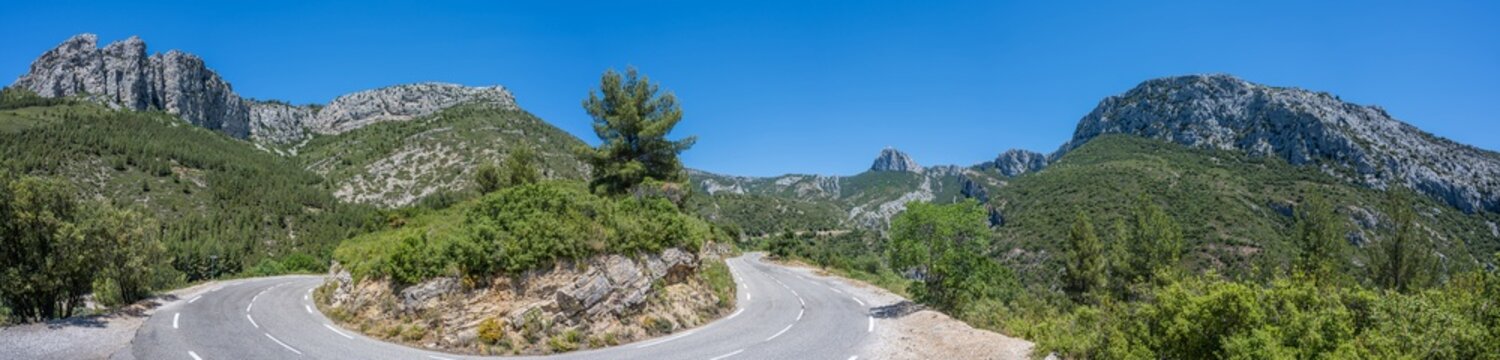 Curved mountain road and panorama view of the landscape around "vallon st pons" near Gemenos in the Bouches-du-Rhône department, Provence-Alpes-Côte d’Azur. "Pic de Bertagne" visible in background.