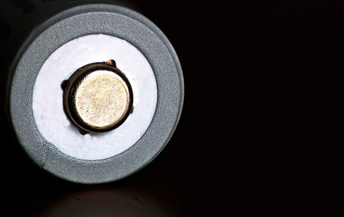 The positive side of a battery on a black background