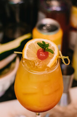 Drink with color harmony with orange and cherry and decorated