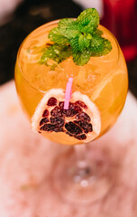 Drink decorated with dried fruit and orange and mint