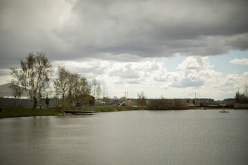 Lake in rainy weather. Pond in woods. Countryside.