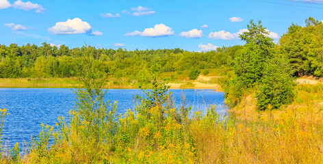 Fototapeta na wymiar Beautiful quarry lake dredging pond lake blue turquoise water Germany.