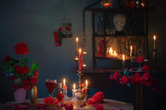 Magic Potion With Red Roses And Burning Candles In Dark Room