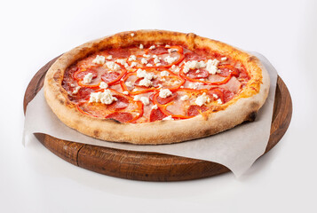 Top view of hot pizza on a wooden stand.