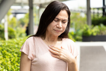 Middle-aged woman having gerd acid reflux, heartburn inflammation - obrazy, fototapety, plakaty