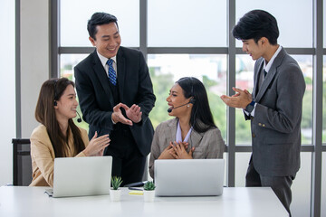 The supervisor compliments and encourage the employees in the office, business concept.