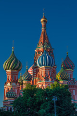 Fototapeta na wymiar Colorful domes of St. Basil's Cathedral at sunrise against vivid blue sky, Moscow, Russia