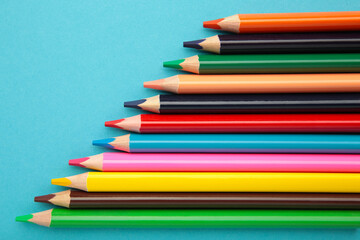 Color pencils on blue background. Close up.
