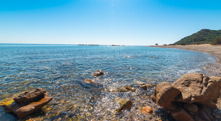 Sun shining over Baccu e Praidas beach in summer