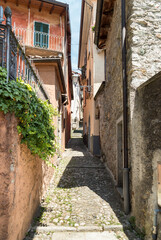 Narrow cobblestone streets with stone houses in the small ancient village Naggio in the province of Como, Lombardy, Italy