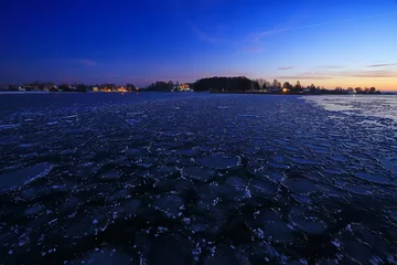 Fototapeten freezing sea ice round pieces, ocean background winter climate coast © kichigin19