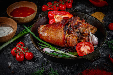 Pork roast roll on a dark stone table garnished with cherry tomatoes. Porchetta, a delicious pork roast from the Italian culinary holiday tradition. Fast food restaurant, delivery service.