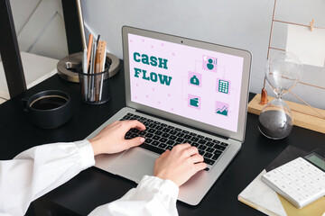 Woman working with modern laptop in office. Cash flow