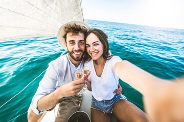 Happy couple of lovers enjoying sail boat trip experience in the ocean - Boyfriend and girlfriend...