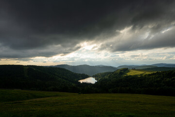 dark sunset over a lake in the Vosges 