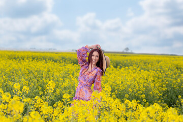 Naklejka na ściany i meble Springtime.Enjoy and relax in nature.Girl in yellow field