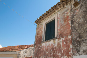 Green rotten wooden window and doors at old abandoned stone house at Corfu Greece