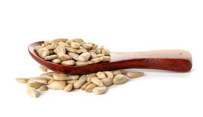 Wooden spoon and peeled sunflower seeds on white background