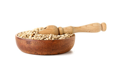 Wooden bowl and scoop with peeled sunflower seeds on white background