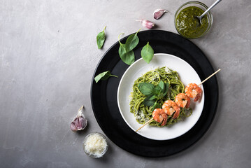 Spaghetti in pesto sauce with tiger prawns