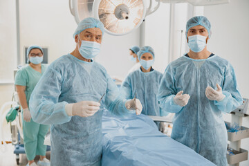 Team of surgeons in the operating room ready for surgery and waiting on patient