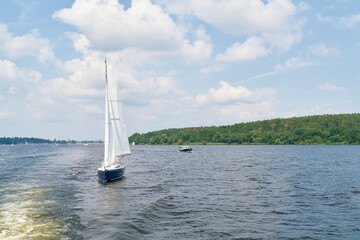 A sailing ship on the Havel river near Berlin. In the background the district of Spandau - 516051355