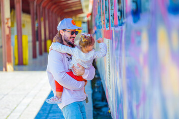 father with her child in love on the railway station in varna bulgaria  - obrazy, fototapety, plakaty
