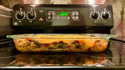 Wheat-free, gluten-free vegan lasagne, made with sheets of sweet potato, cut to replace pasta, resting in casserole dish on stove top