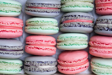 Pink, lilac and mint macaron cookies in the box.