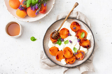 Grilled apricots with buratta cheese , granola and honey. Summer breakfast