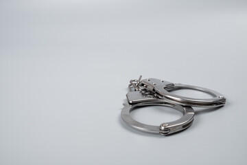 handcuffs on a black background close-up, arrest detention copy space.