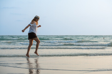 Young Asian woman enjoying on the beach on holiday.