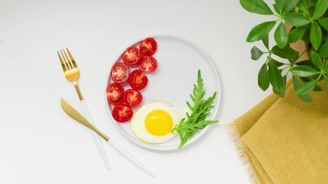Healthy keto breakfast: egg, avocado, arugula, tomatoes and bacon. Stop Motion Animation