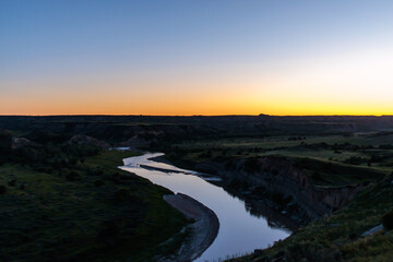 The sunsets over the Missouri River at dusk at Theodore Roosevelt National Park in North Dakota
