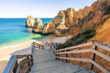 Wooden footbridge to beach Praia do Camilo near Lagos in Algarve, Portugal.