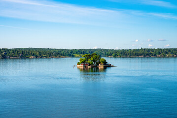 Distant view of summer houses on islands of Archipelago. Picturesque scenery of settlement amidst...