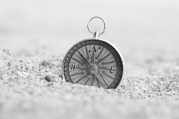 black and white photo of round compass