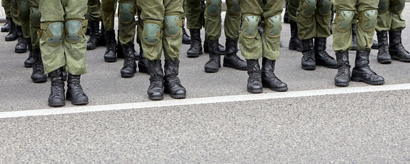 Soldiers in military camouflage uniforms in army formation.