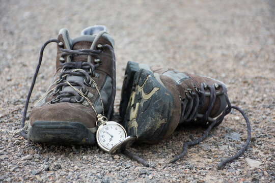 Old shoes and pocket watch on street, vintage style
