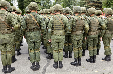 Soldiers in military camouflage uniforms in army formation.