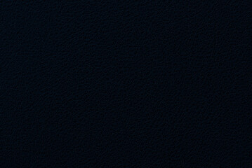 Black plastic background texture with bluish tint. Image from above