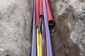 Electric cable underground. Broadband and power Lines in various colors and types of tube....
