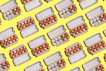 Chicken eggs pattern. top view of Mockup or packaging design, paper box with chicken eggs on a yellow background, eco friendly or green product. Open cardboard box with chicken eggs..
