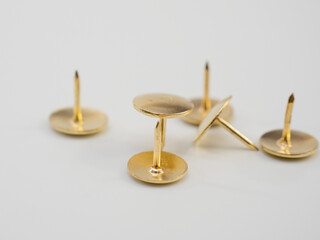 Set of golden thumbtacks.