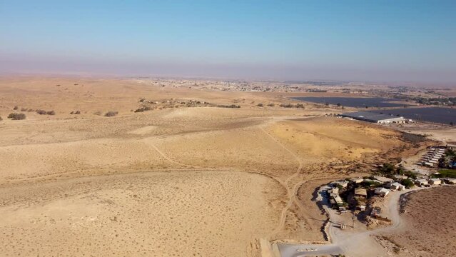 Long time panoraming flight over Sheizaf settlement at early morning in Negev desert