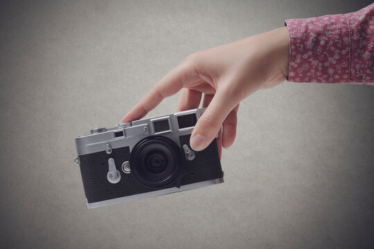 Woman holding a vintage camera