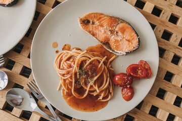 Homemade salmon spaghetti with tomato sauce served for lunch.