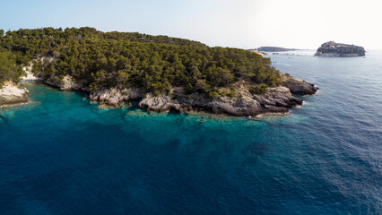 Fototapeta premium Italy, July 2022. Aerial view of the Quakes islands with their Caribbean sea
