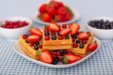 
Morning breakfast with cup of tea, waffles and berries

