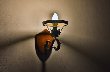 old interior wall sconce with bulb and cobwebs